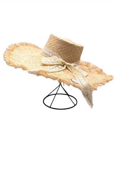 STRAW HAT WITH FRINGE ON THE EDGES AND DECORATED WITH A BOW TIE