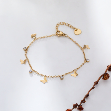 Wholesaler Eclat Paris - Golden chain bracelet with butterfly and rhinestone tassels