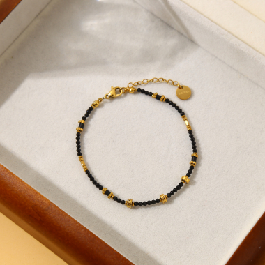 Grossiste Eclat Paris - Bracelet doré avec pierres noires et dorées